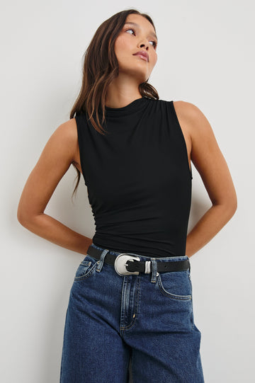 Christen Sleeveless Top with a Mock Neck and Ruching Along One Side Seam in Black Colorway - Front View Featured on Model