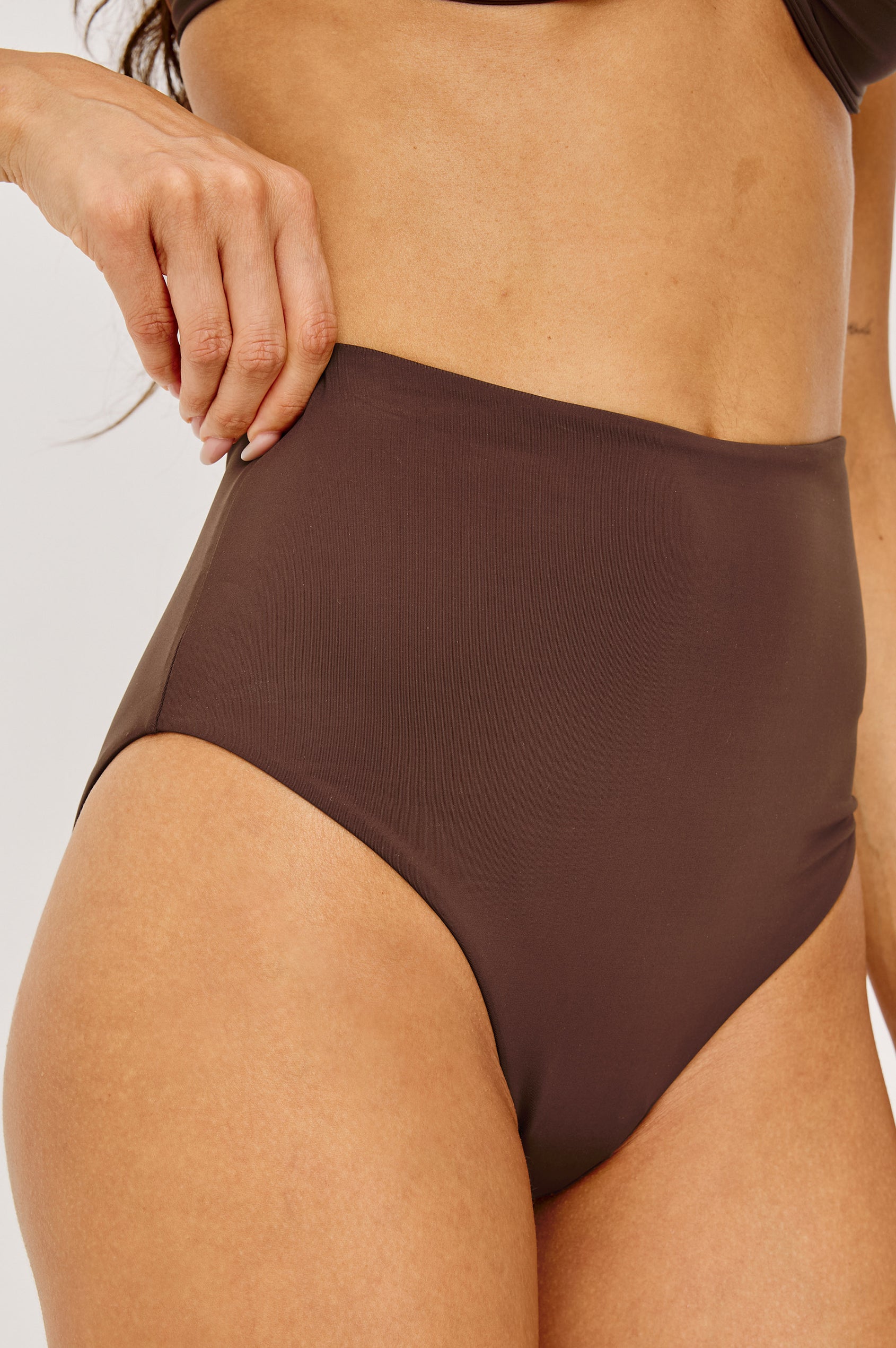Cielo Bikini Bottom With High Waist, High-Cut Legs, and Cheeky Rear Coverage in Espresso Colorway - Lower Body Front View Featured on Model