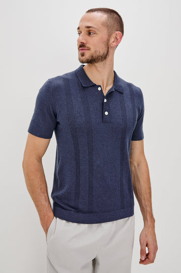 Cillian short sleeve cotton silk blend polo with three button placket and retro  front stripe details in Indigo Denim - front view on model 
