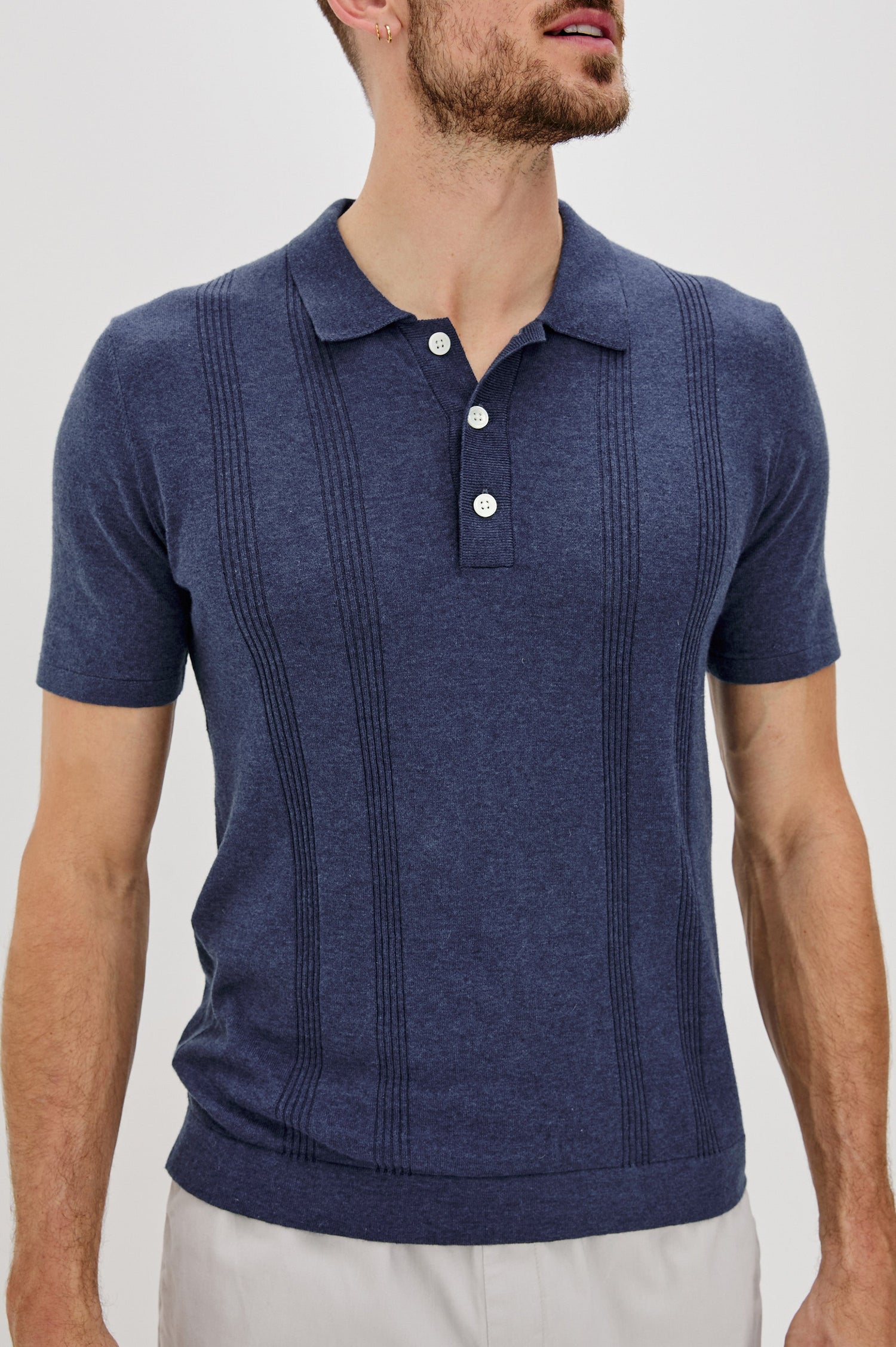 Cillian short sleeve cotton silk blend polo with three button placket and retro  front stripe details in Indigo Denim - front detail view on model 