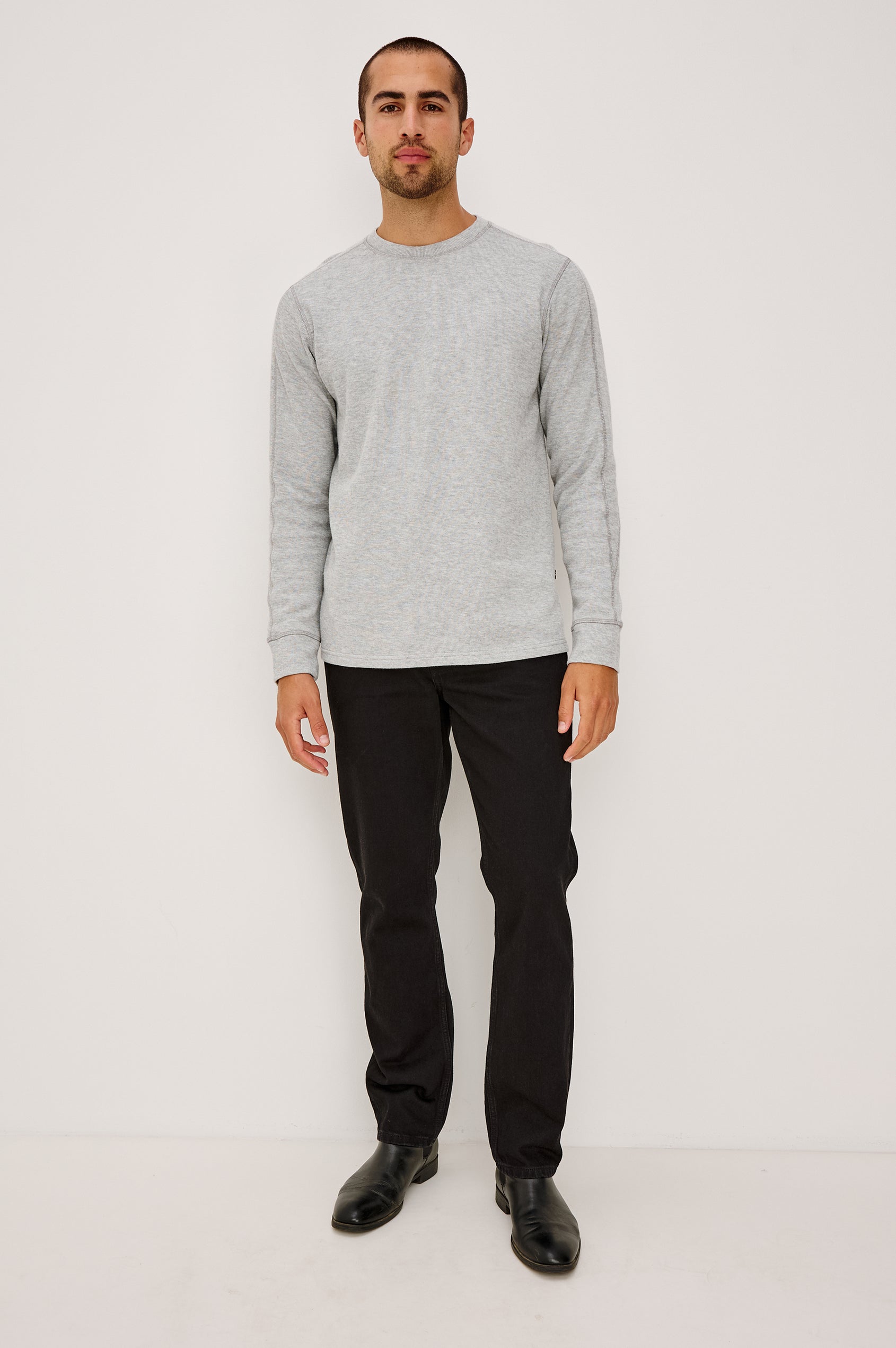 Clayton Slim Straight Jean With 5-Pocket Styling, Belt Loops, and Front Zip-Fly in Dark Black Colorway - Full Body Front View Featured on Model