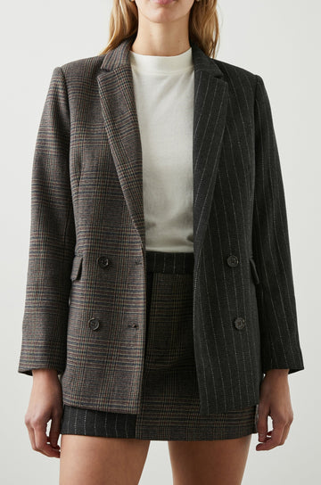 Cody Double-Breasted Blazer with Two Button Closure, Two Front Flap Pockets, and Four-Button Cuffs in Pinstripe Plaid Mix Colorway, the Right Half is a Plaid in Brown, Blue and Red, the left half is White pinstripe on Black - Front View Featured on Model