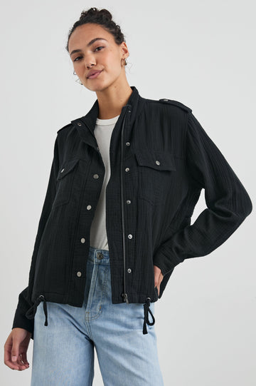 Collins Jacket with Zip and Snap Closure, Two Chest Snap Flap Pockets, Toggle Drawstring Hem, Snap Shoulder Straps and a Breathable Back Flap in Gauze Black Colorway - Front View Featured on Model