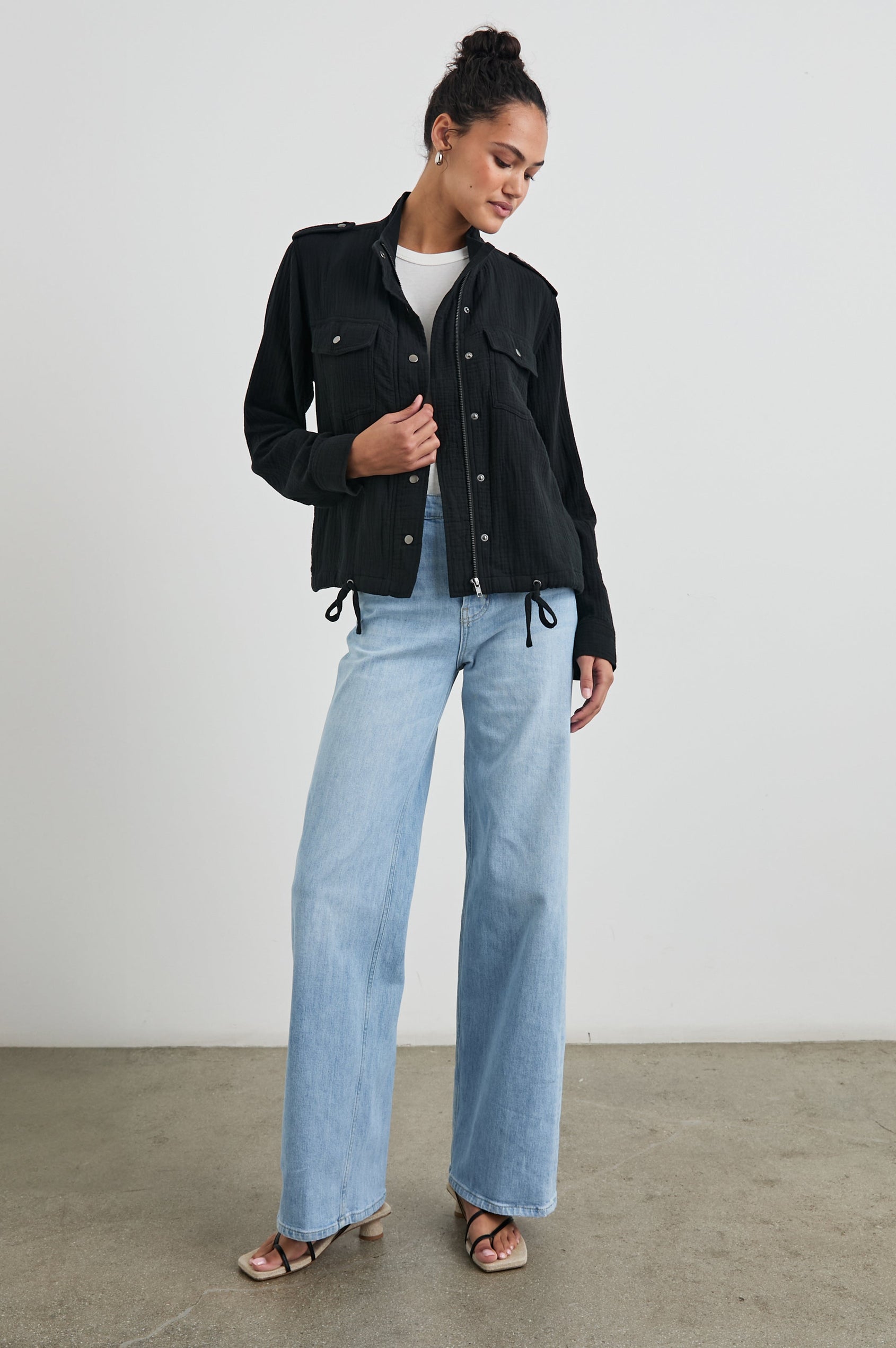 Collins Jacket with Zip and Snap Closure, Two Chest Snap Flap Pockets, Toggle Drawstring Hem, Snap Shoulder Straps and a Breathable Back Flap in Gauze Black Colorway - Front Full Body View Featured on Model