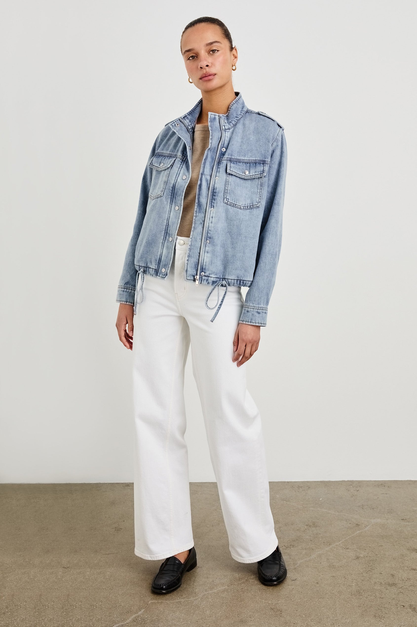 Collins military style jacket with cargo chest pockets and drawstring hem in Faded Indigo - full body front view on model