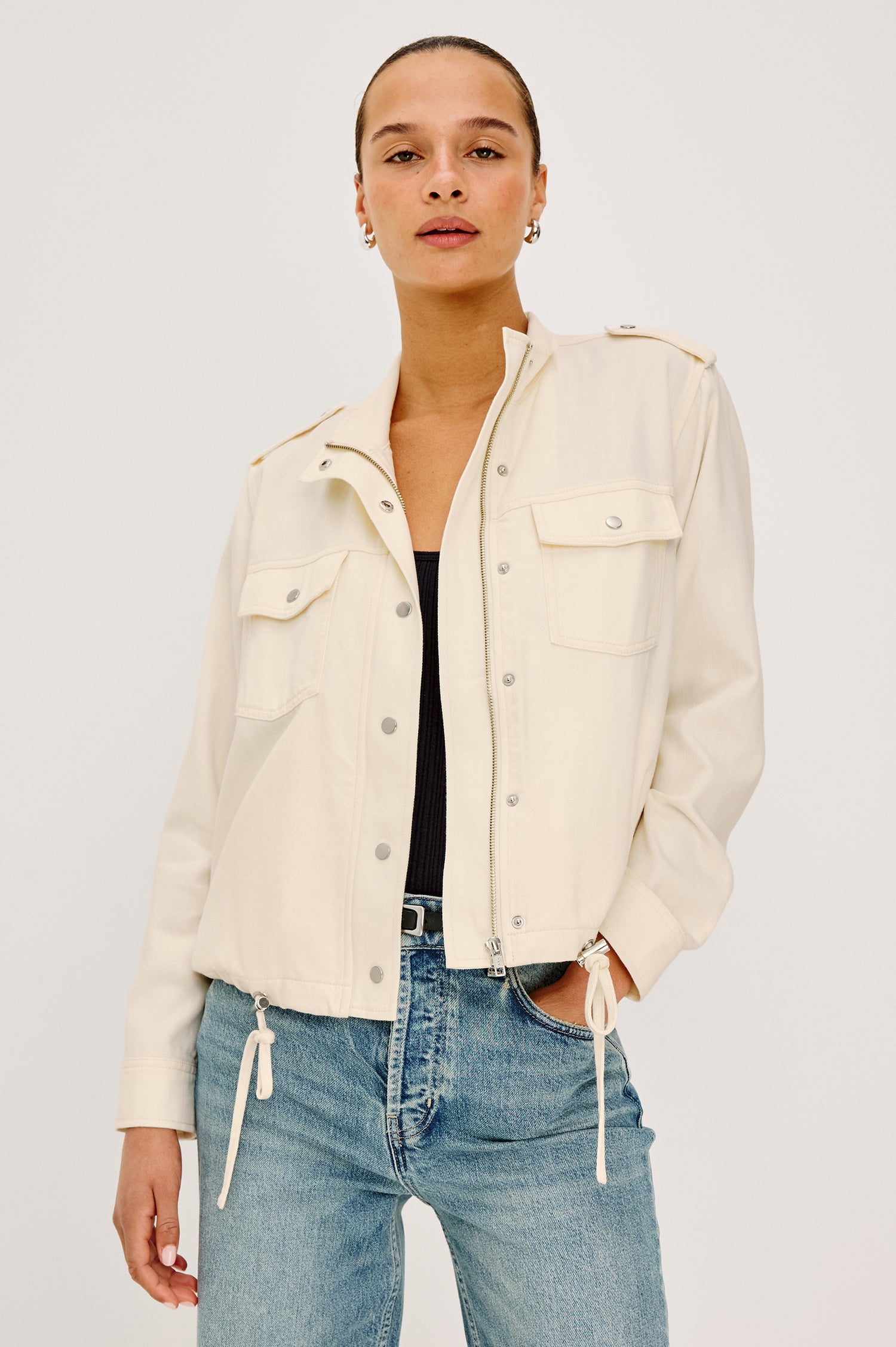 Collins Miitary Inspired Jacket With Shoulder Epaluettes, Stand Collar, Front Snap Buttons, Double Chest Pockets, Long Sleeves in Ivory Colorway - Upper Body Front View Featuered on Model