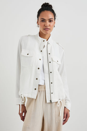 Collins Jacket with Zip and Snap Closure, Two Chest Snap Flap Pockets, Toggle Drawstring Hem, Snap Shoulder Straps and a Breathable Back Flap in Gauze White Colorway - Front View Featured on Model