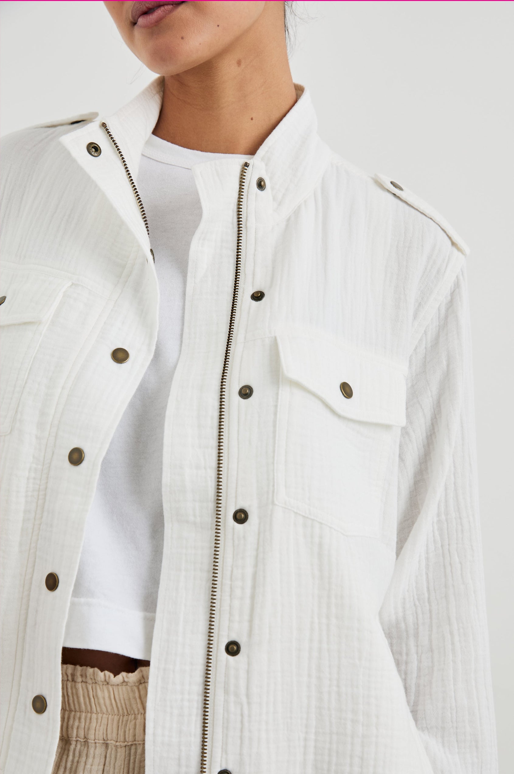Collins Jacket with Zip and Snap Closure, Two Chest Snap Flap Pockets, Toggle Drawstring Hem, Snap Shoulder Straps and a Breathable Back Flap in Gauze White Colorway - Front View Featured on Model