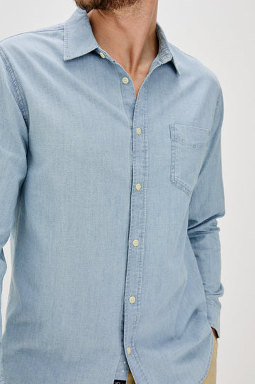 Colton Long-Sleeve Denim Button Up with a Chest Patch Pocket in Medium Vintage Wash Colorway - Front Detail View Featured on Model 