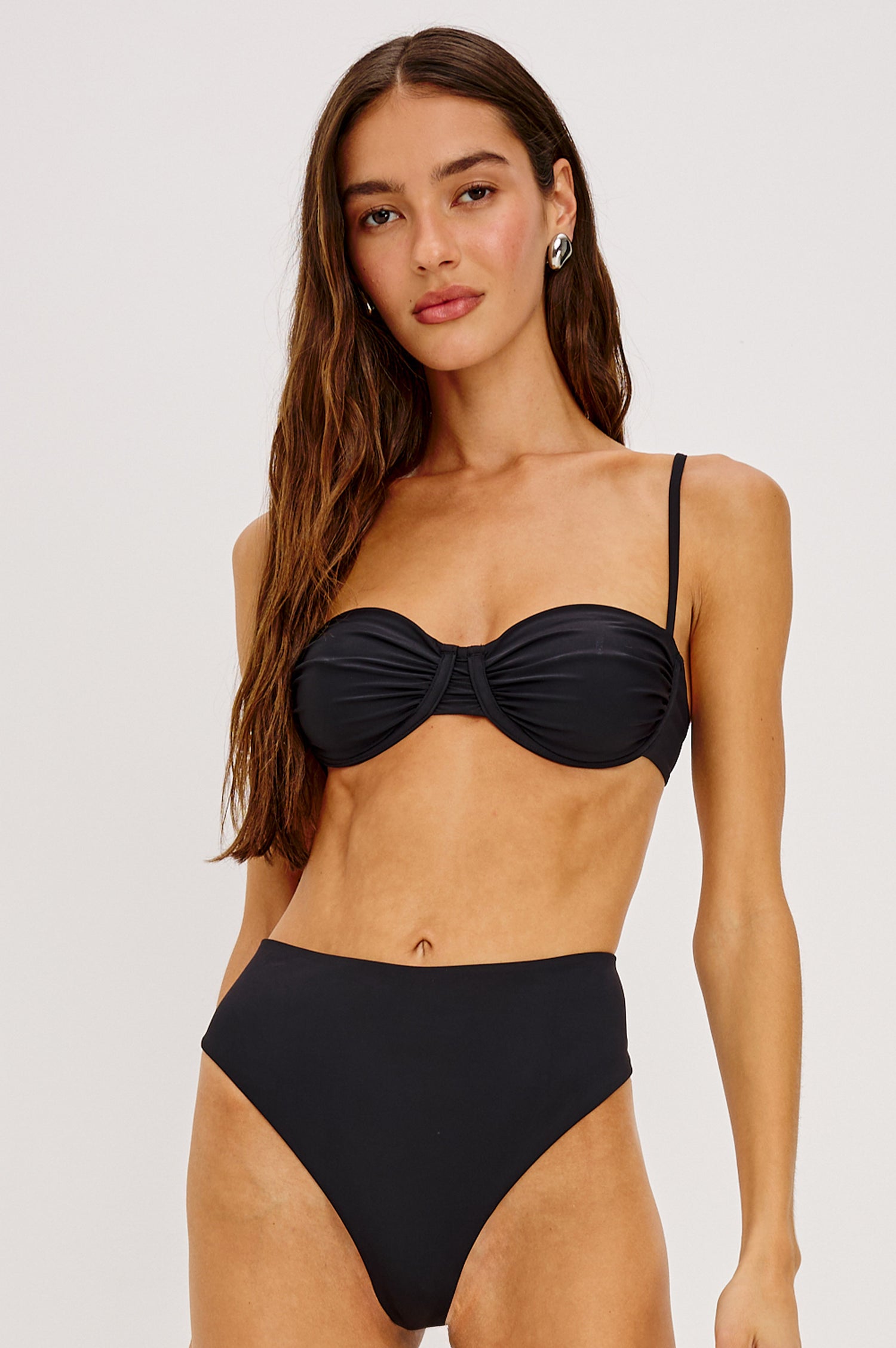 Concha Bikini Top With Balconette Shape, Ruched Underwire Bust Cups, Adjustable Shoulder Straps, and Back Hook Closure in Black Colorway - Upper Body Front View Featured on Model
