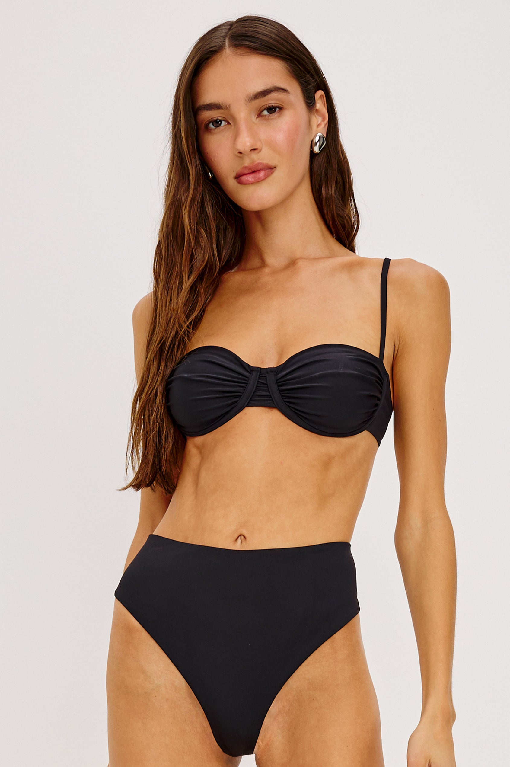 Concha Bikini Top With Balconette Shape, Ruched Underwire Bust Cups, Adjustable Shoulder Straps, and Back Hook Closure in Black Colorway - Upper Body Front View Featured on Model