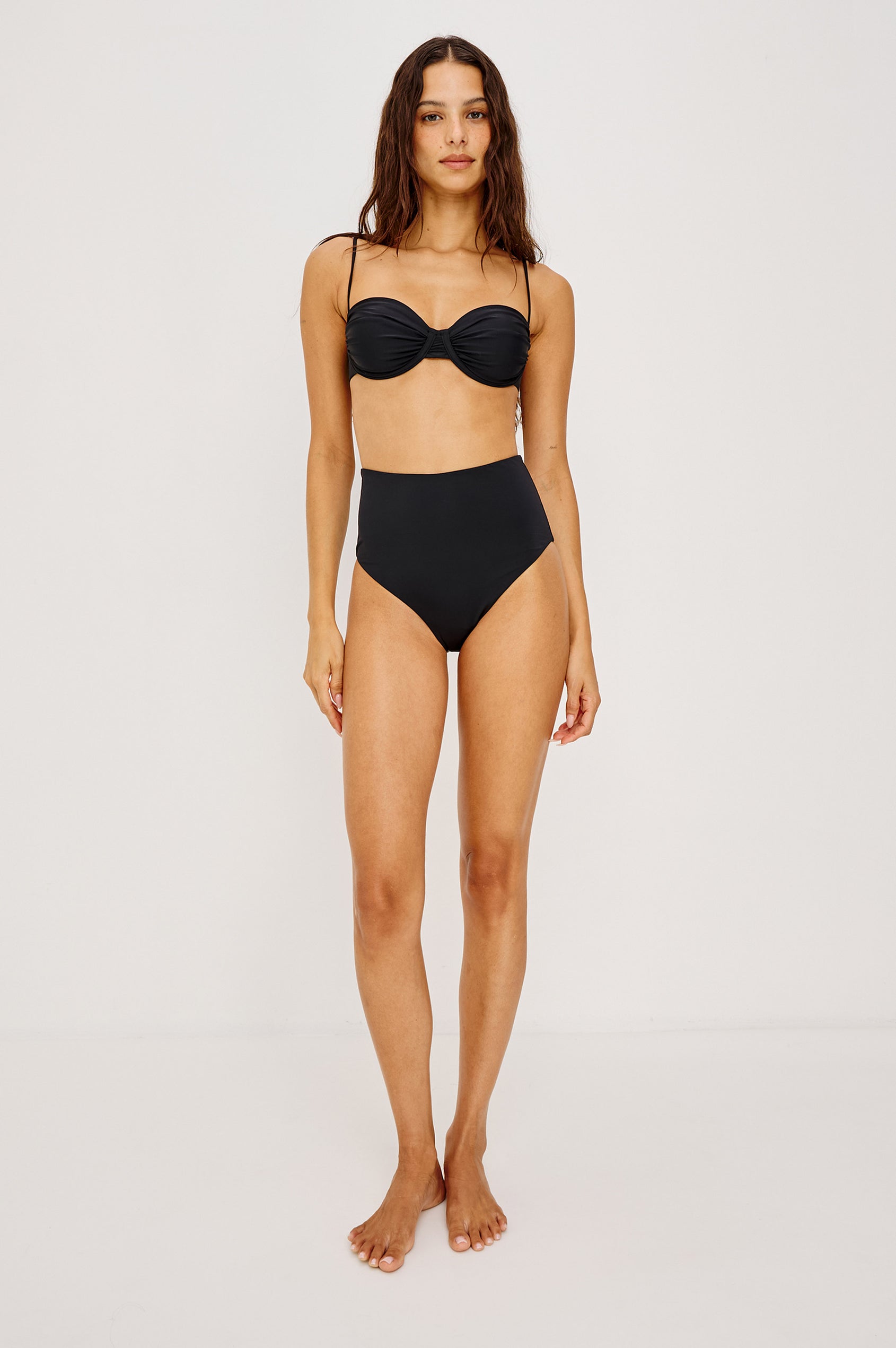Concha Bikini Top With Balconette Shape, Ruched Underwire Bust Cups, Adjustable Shoulder Straps, and Back Hook Closure in Black Colorway - Full Body Front View Featured on Model