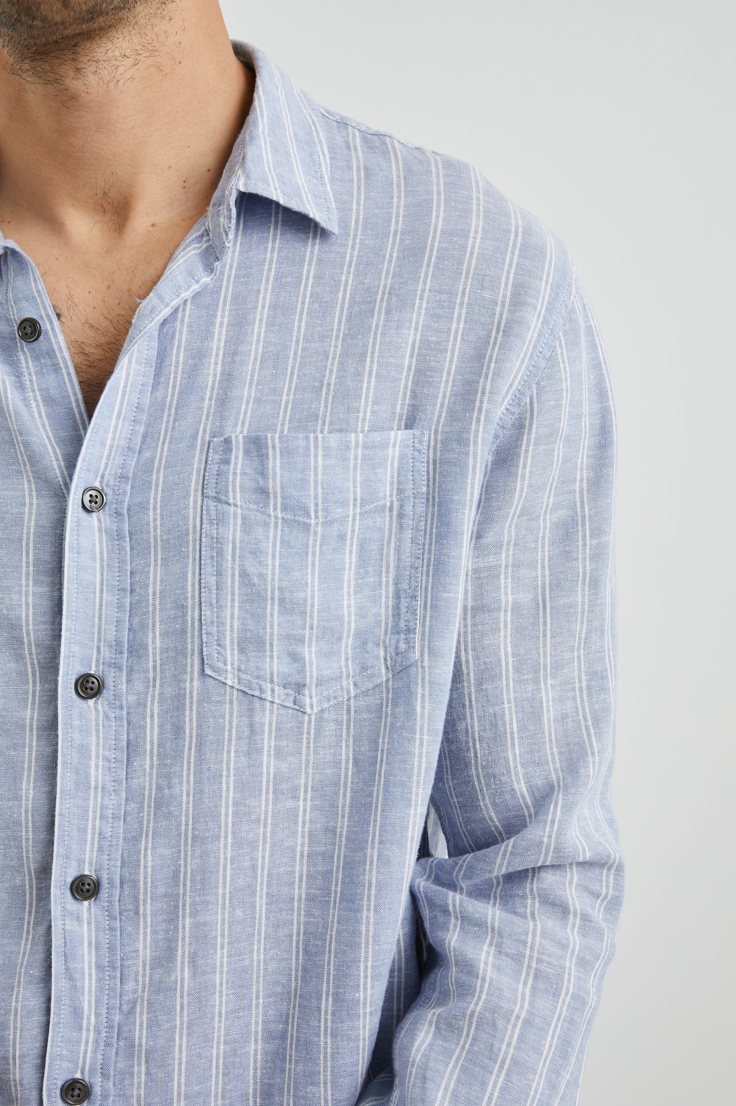 Connor Long-Sleeve Button Up with a Chest Patch Pocket in Denim White Pinstripe Colorway - Front View Featured on Model