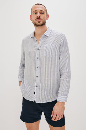 Connor Long-Sleeve Button Up with a Chest Patch Pocket in Denim White Railroad Colorway, Vertical Stripes - Front View Featured on Model