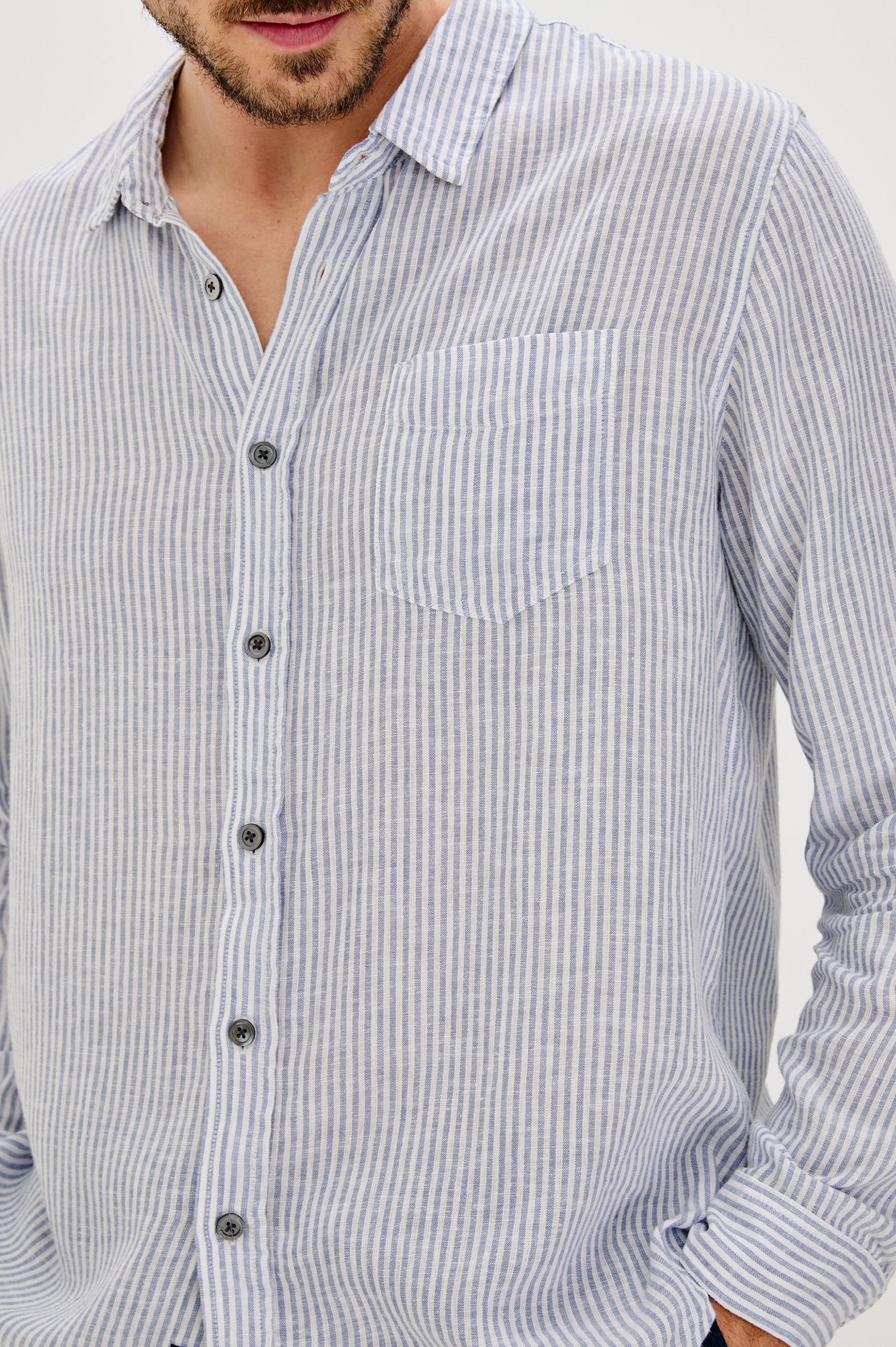 Connor Long-Sleeve Button Up with a Chest Patch Pocket in Denim White Railroad Colorway, Vertical Stripes - Front View Featured on Model