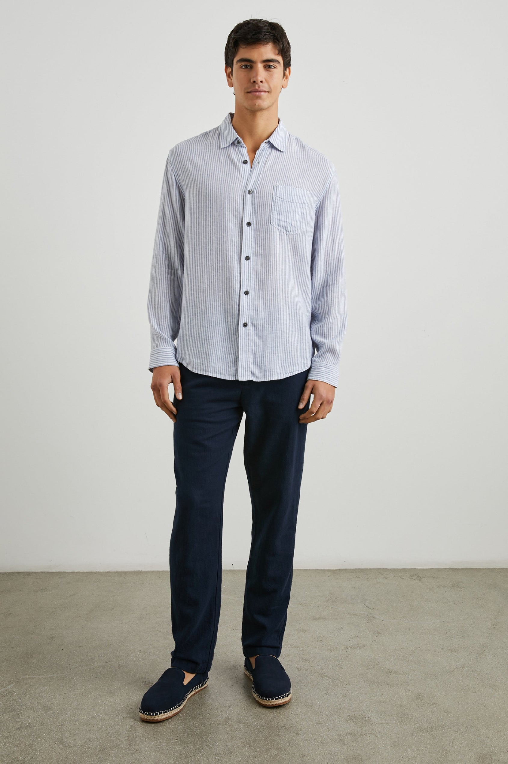 Connor Long-Sleeve Button Up with a Chest Patch Pocket in Denim White Railroad Colorway, Vertical Stripes - Front Full Body View Featured on Model