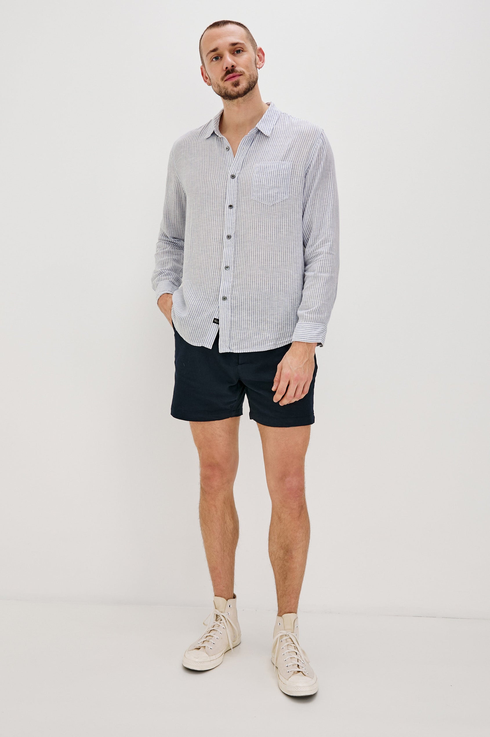 Connor Long-Sleeve Button Up with a Chest Patch Pocket in Denim White Railroad Colorway, Vertical Stripes - Front Full Body View Featured on Model