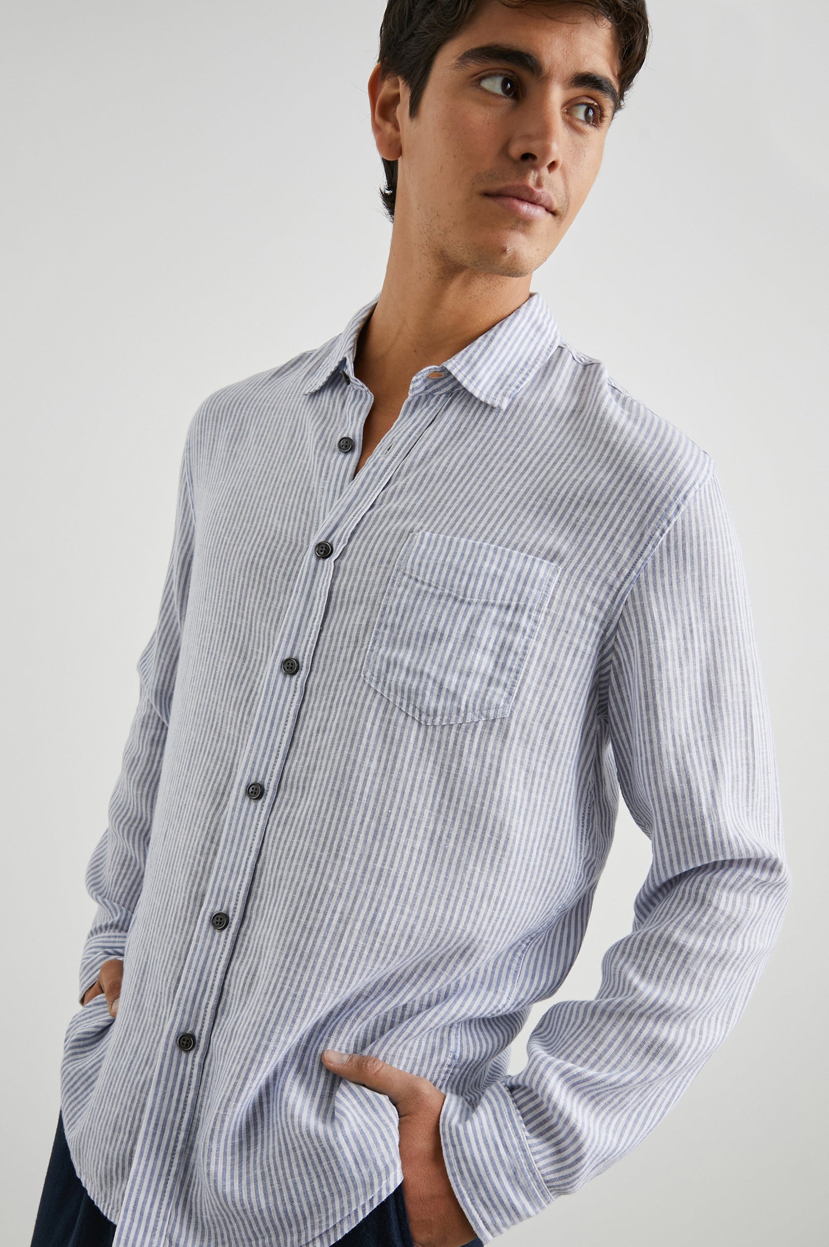 Connor Long-Sleeve Button Up with a Chest Patch Pocket in Denim White Railroad Colorway, Vertical Stripes - Front View Featured on Model
