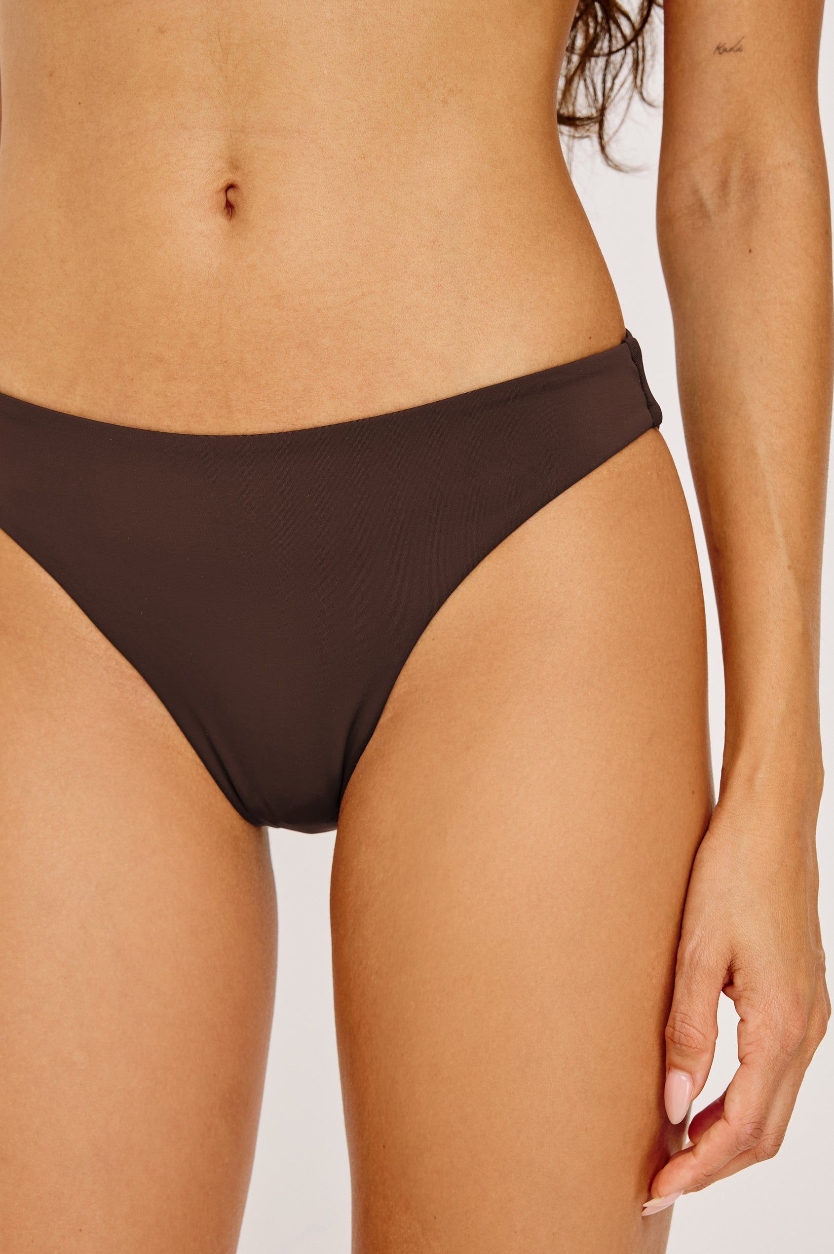 Corsica Bikini Bottom With Fixed Side Straps and Cheeky Rear Coverage in Espresso Colorway - Lower Body Front Close Up View Featured on Model