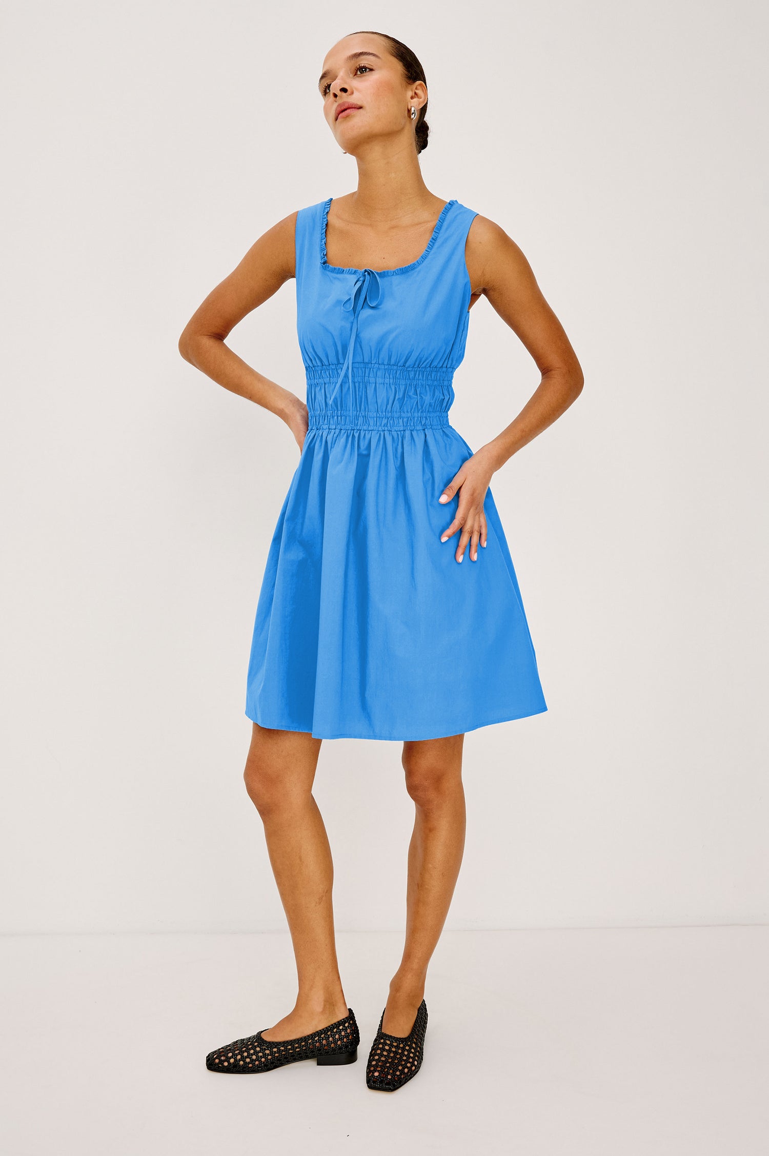 Cosette Mini Dress in Cotton Poplin With Square Neckline, Center Bust Ties, Ruffle Trim, and Smocked Waist in Harbor Blue Colorway - Full Body Front View Featured on Model