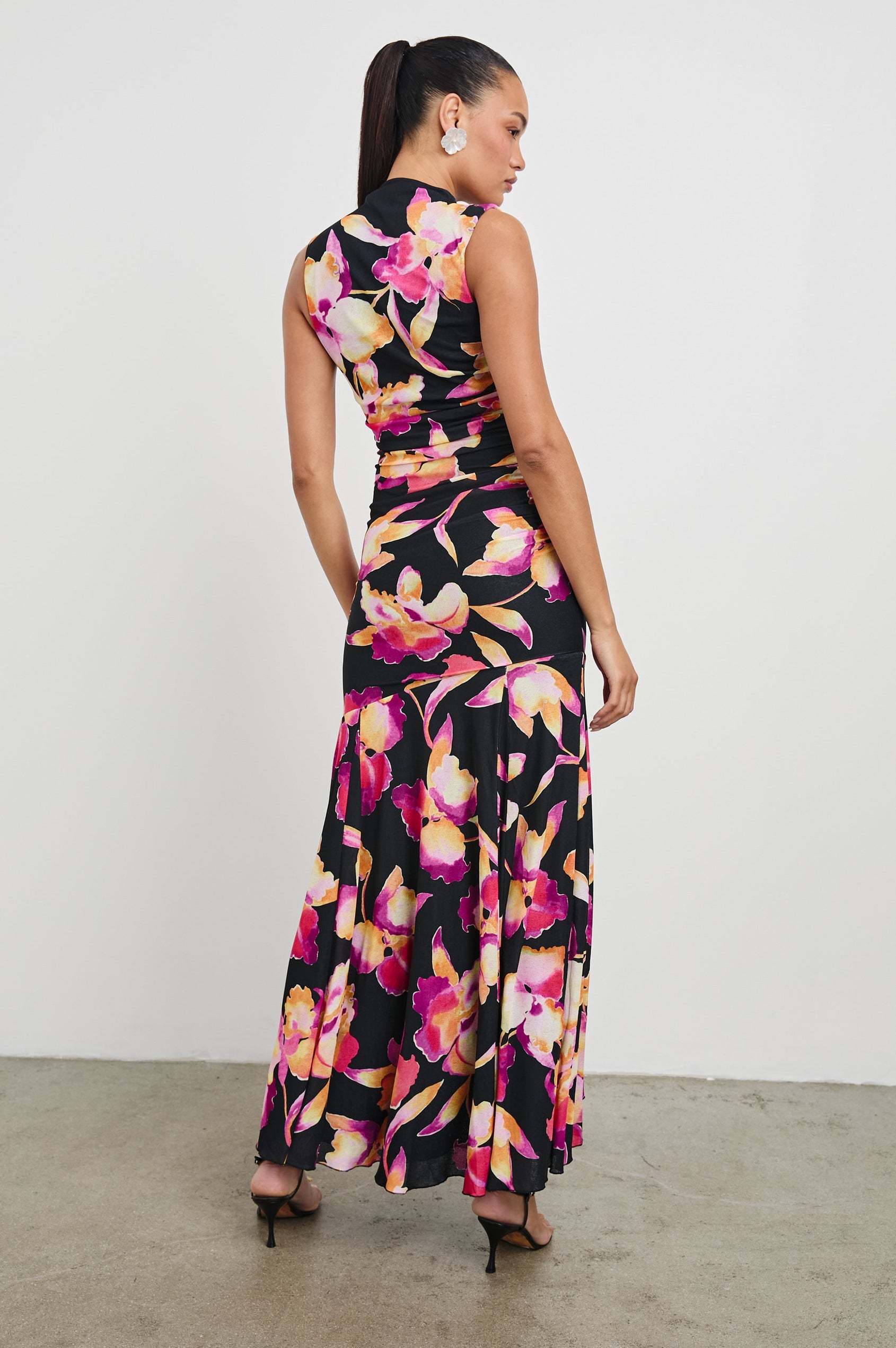 Cosmos Maxi-Length Dress with a Cowl Neck, Sleeveless, Form Fitting with a Ruched Side Seam Detail and an A-line Hem in Dusk Orchid Colorway. Full Length Back View Shown on Model.