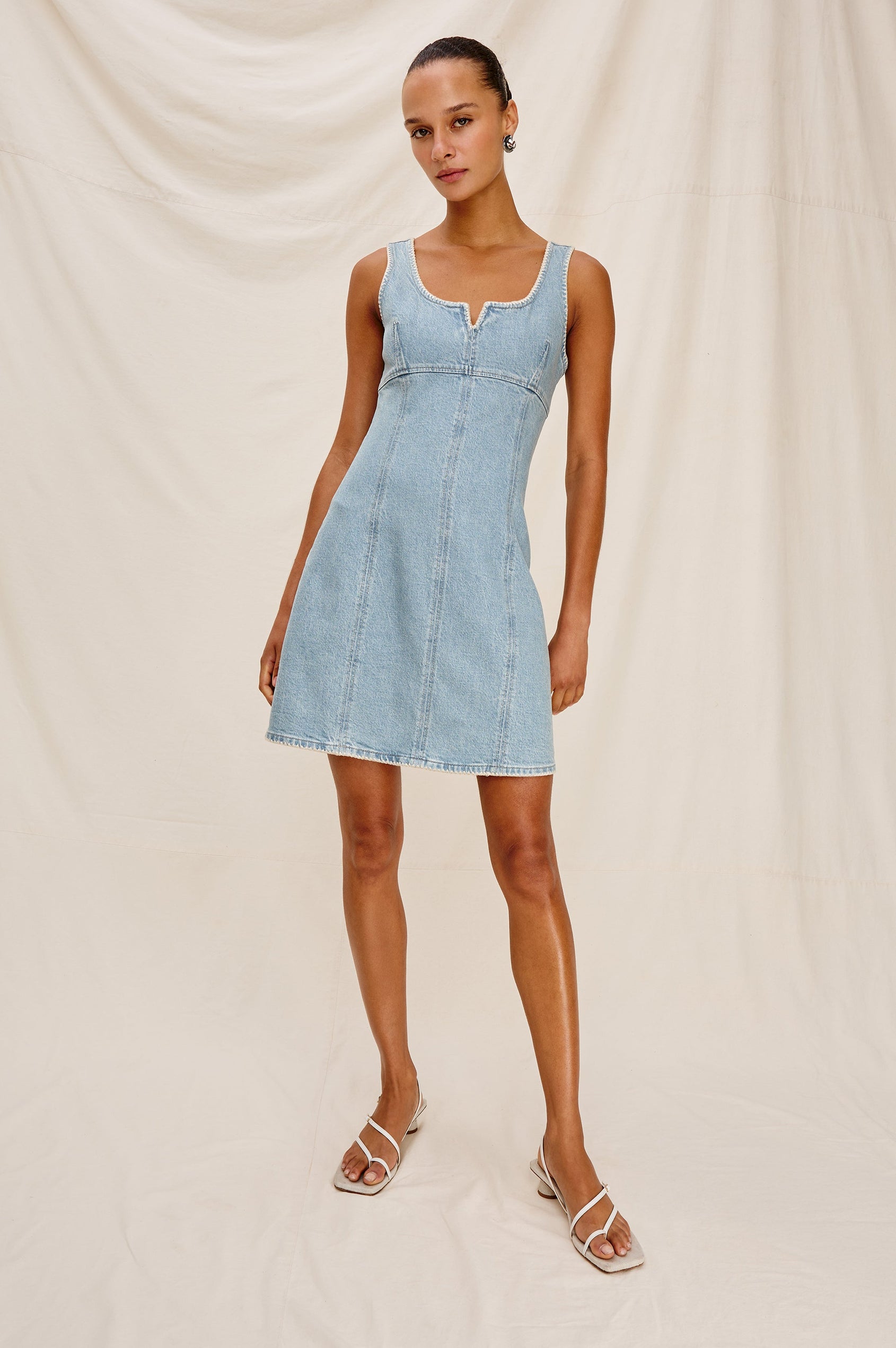 Cove Denim Tank Dress with a Scoop Split neck, Empire Bust, A-line and Above-Knee Length in Capri Colorway.  Full Body Front View Shown on Model.