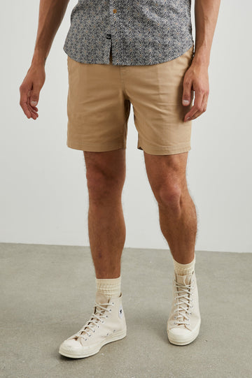 Cruz Shorts with a Drawstring Waist, Two Front Pockets, Two Back Button Flap Pockets in Khaki Colorway - Front View Featured on Model 