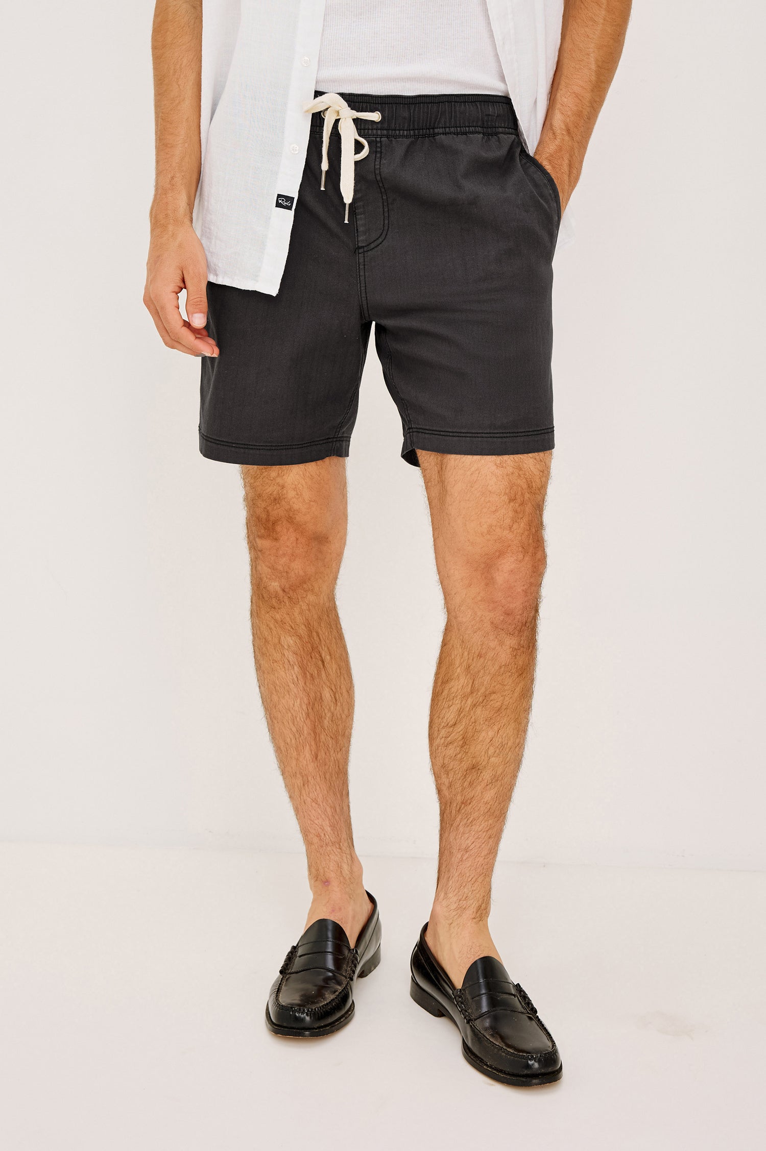 Cruz Short in Stretch Cotton With Drawstring Waist TIes, Side Pockets, and Relaxed Fit in Washed Black Colorway - Lower Body Front View Featured on Model