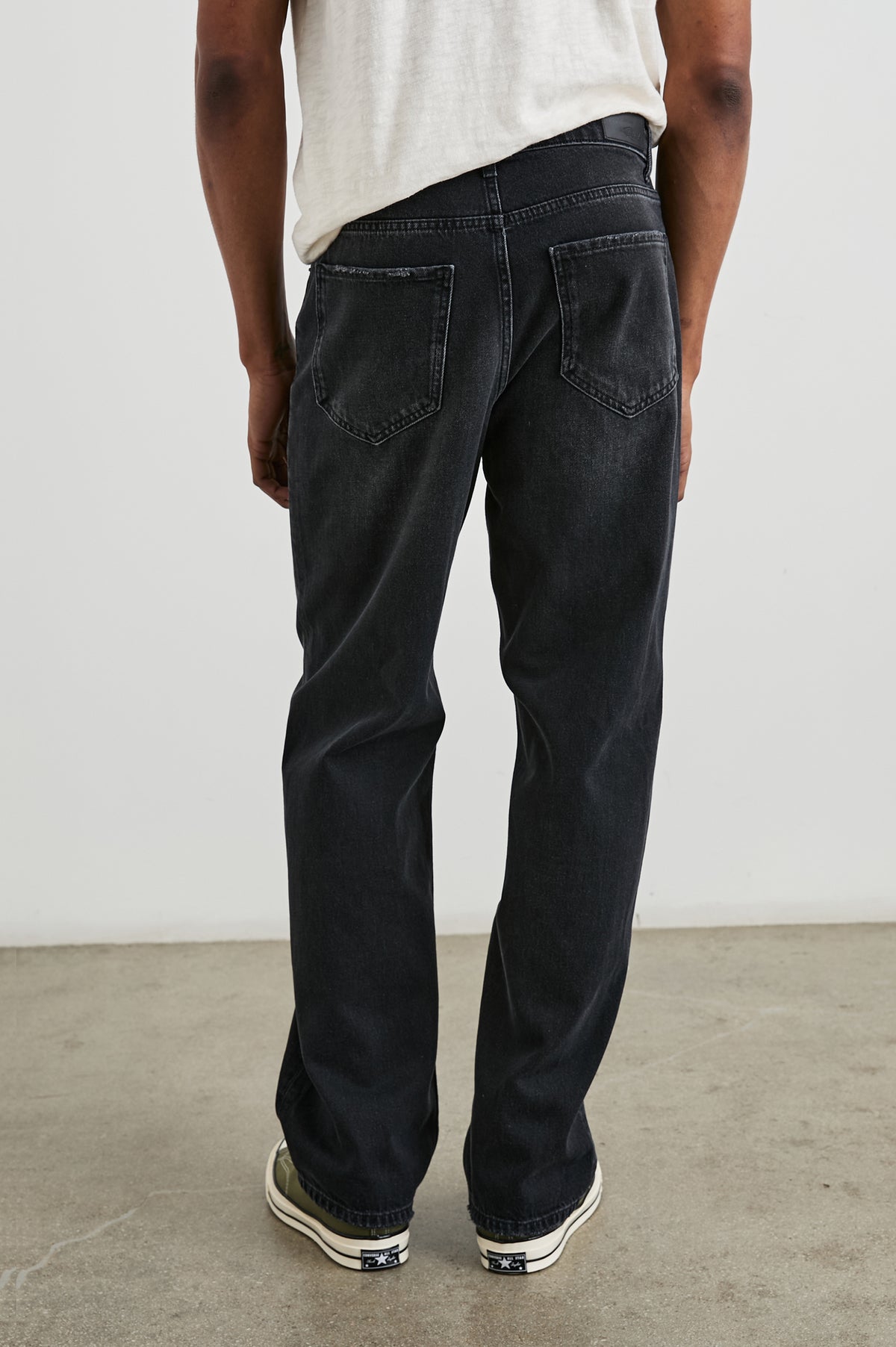 Cutler 90's Loose Jeans with Belt Loops, Two Front Pockets plus a Coin Pocket and Two Back Patch Pockets in Distressed Black Colorway - Back View Featured on Model
