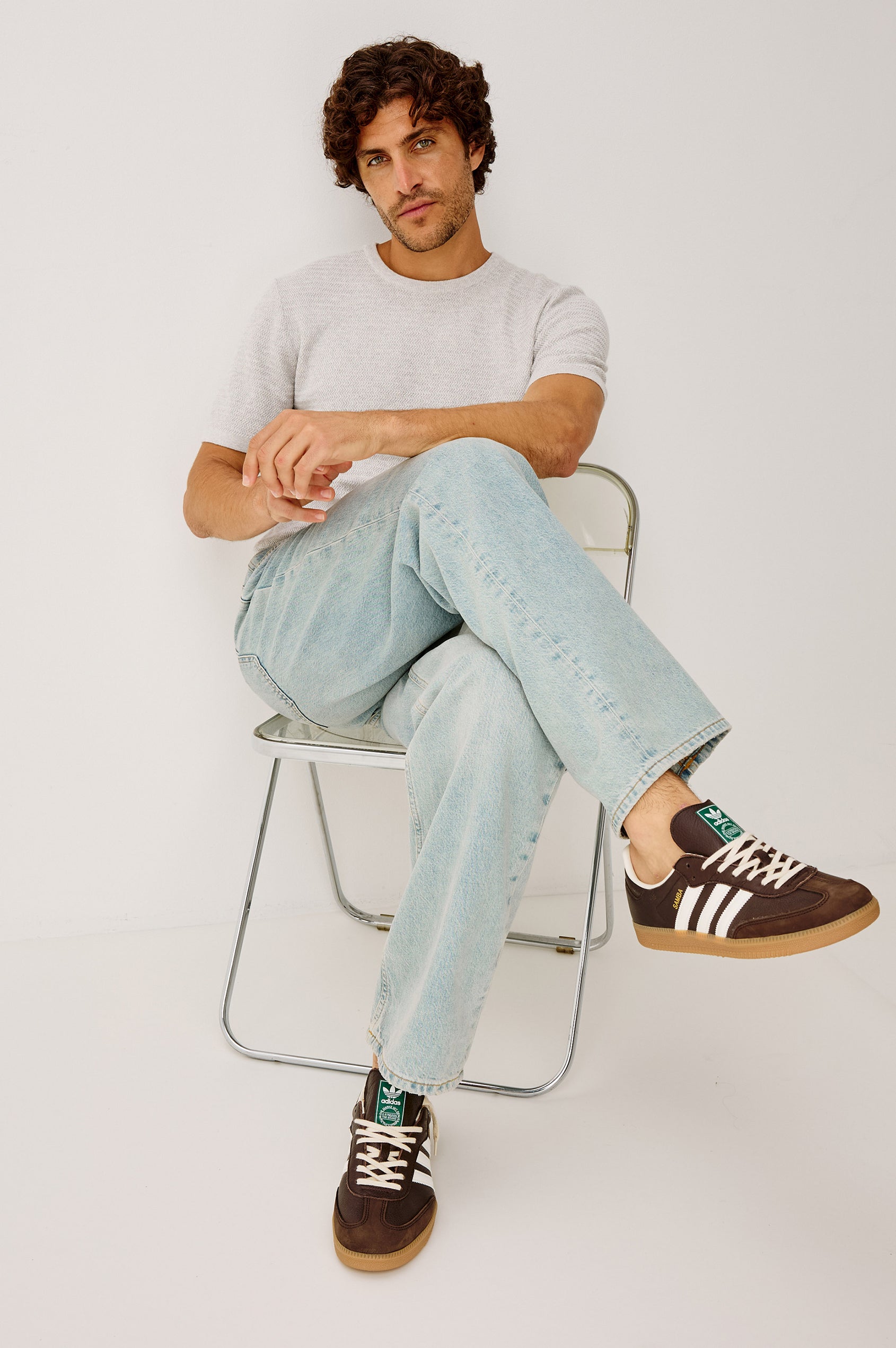 Cutler 90's Loose Jeans with Belt Loops, Two Front Pockets plus a Coin Pocket and Two Back Patch Pockets in Vintage Light Wash Colorway - Front Seated View, Featured on Model