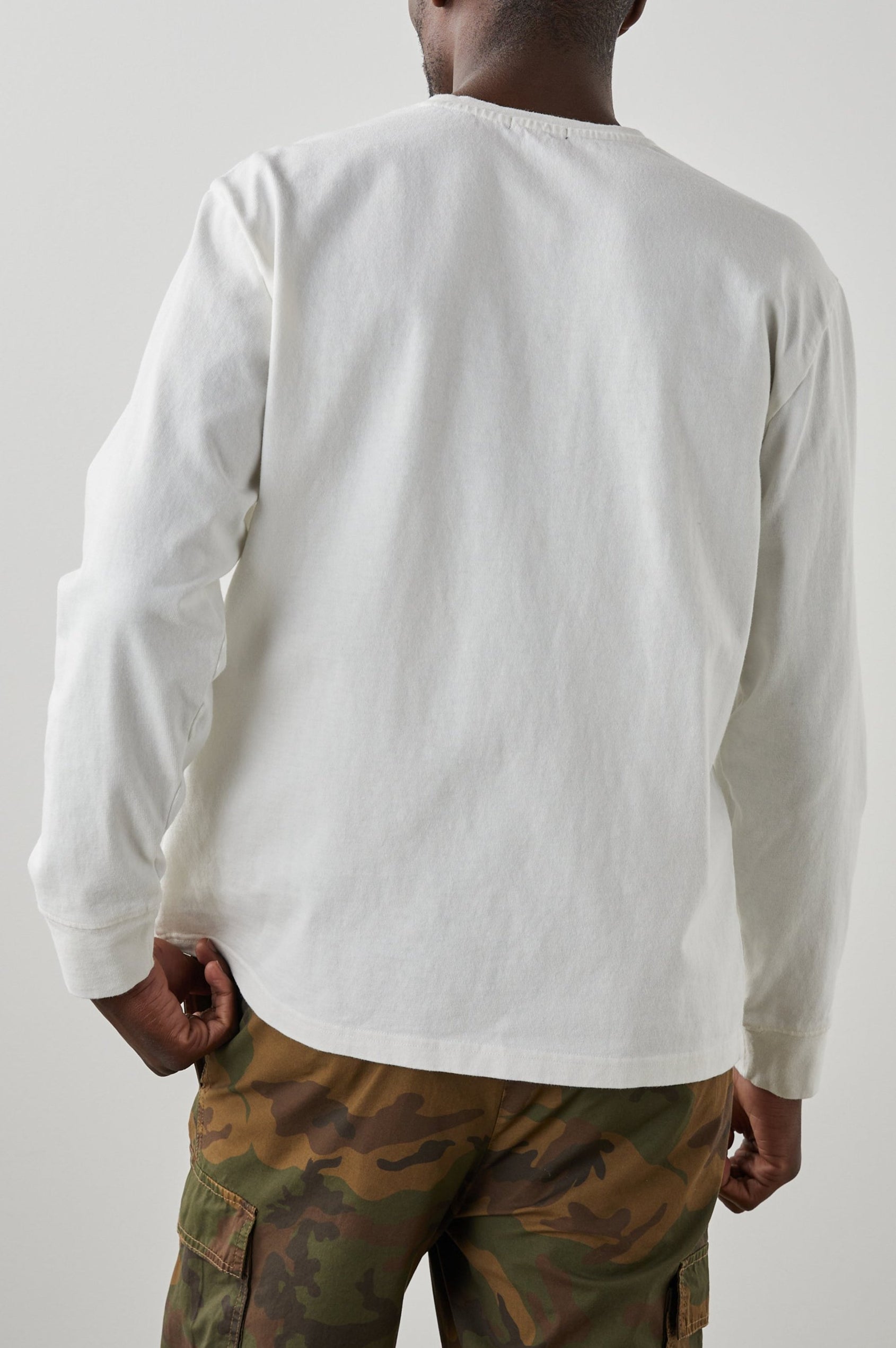 Cyd Long Sleeve Crew Neck T-Shirt  with a Chest Patch Pocket in White Colorway - Back View Featured on Model