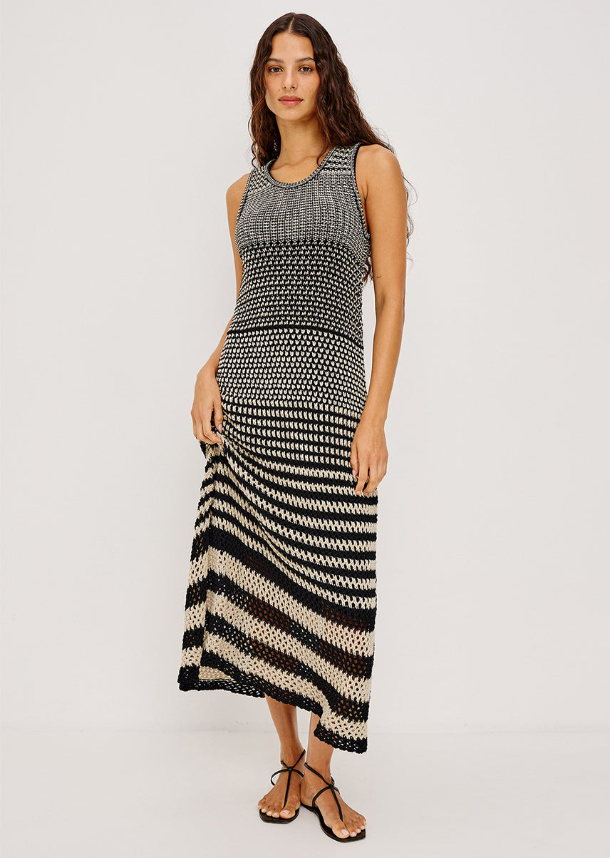 Woman wearing a black and beige maxi dress 