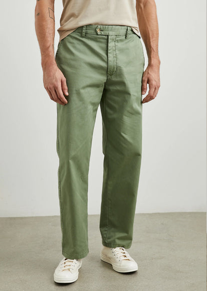 MALE MODEL WEARING GARRETT PANT (STRAIGHT WIDE LEG PANT) IN COLOR SPRING OLIVE (GREEN)