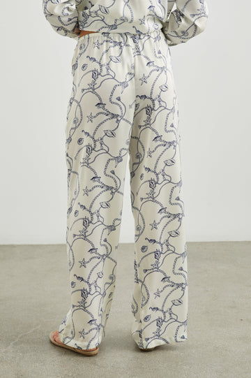 Damini Pants with a Drawstring Waist and Two Front Pockets in Nautical Chain Colorway, with a blue Nautical pattern on white - Back View Featured on Model