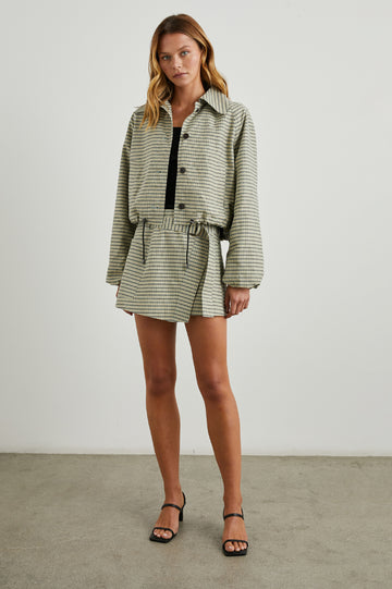 Deanna Mini Wrap Skirt with Fabric Belt and Two Side Pockets in Sage Mini Check Colorway, olive, yellow and sage plaid - Front Full Body View Featured on Model