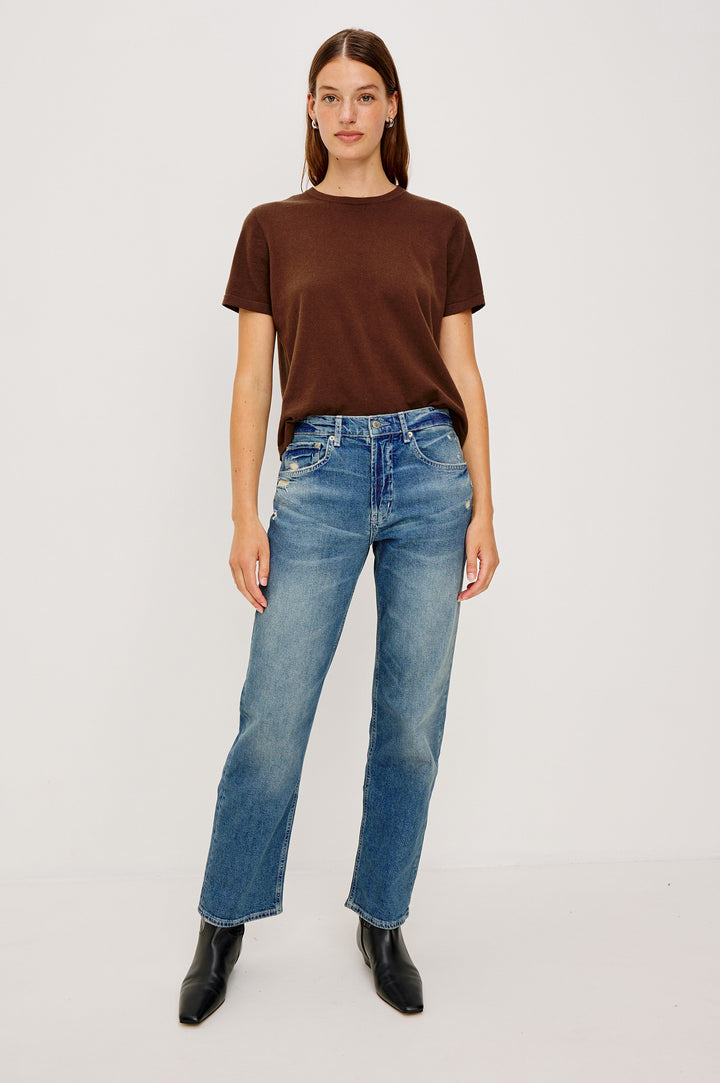Del Mar low slung baggy boyfriend 5-pocket jean in medium wash Tinted Indigo Destroy, with light destruction near front pockets - front full body view featured on model.