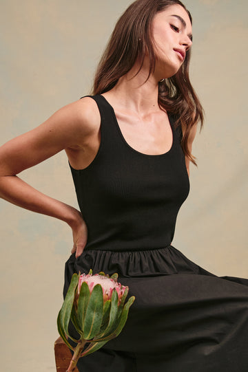 Dia tank midi dress with scoop neck and fitted bodice in Black - stylized close up view on model with flower