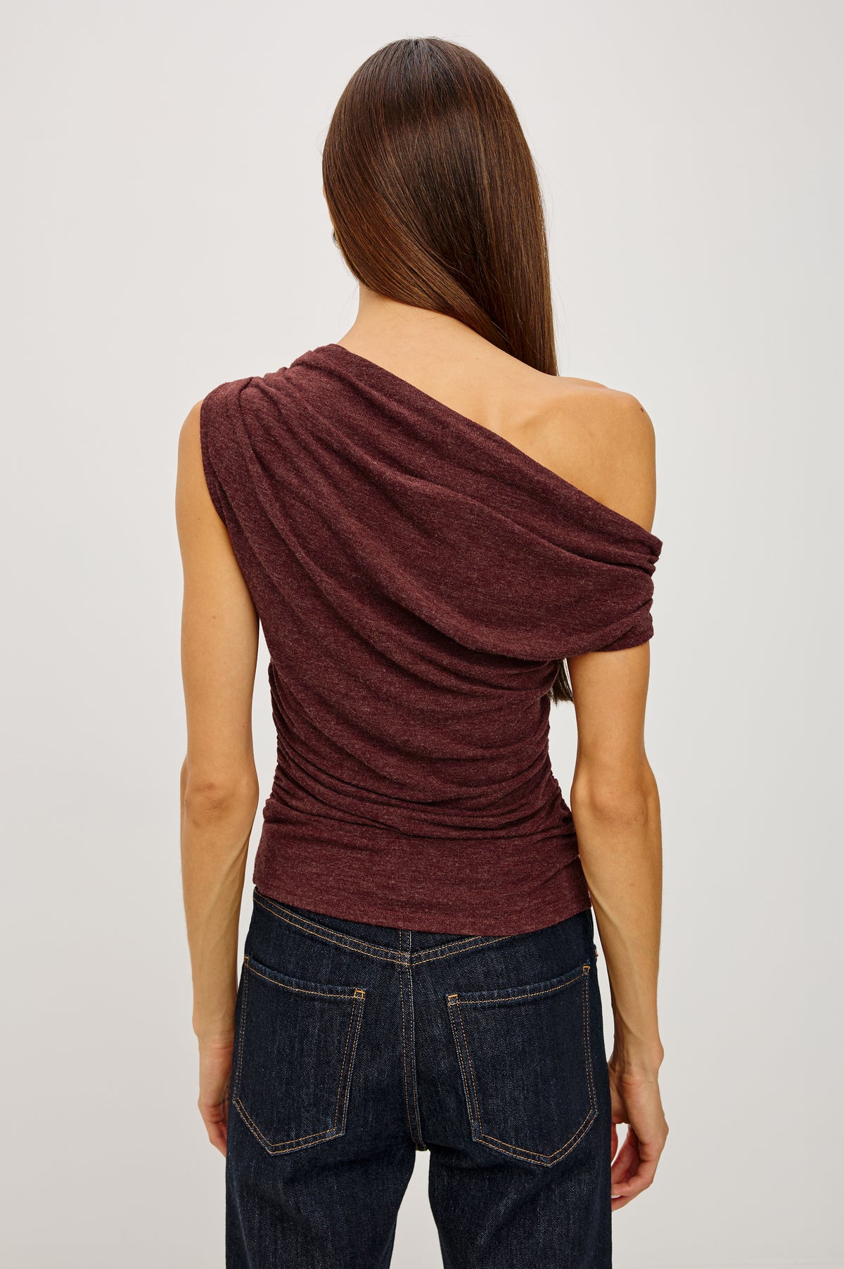 Dominic Top in Soft Jersey With Off-The-Shoulder One-Shoulder Design, Shirred Shoulders, and Ruched Waist in Merlot Colorway - Upper Body Back View Featured on Model
