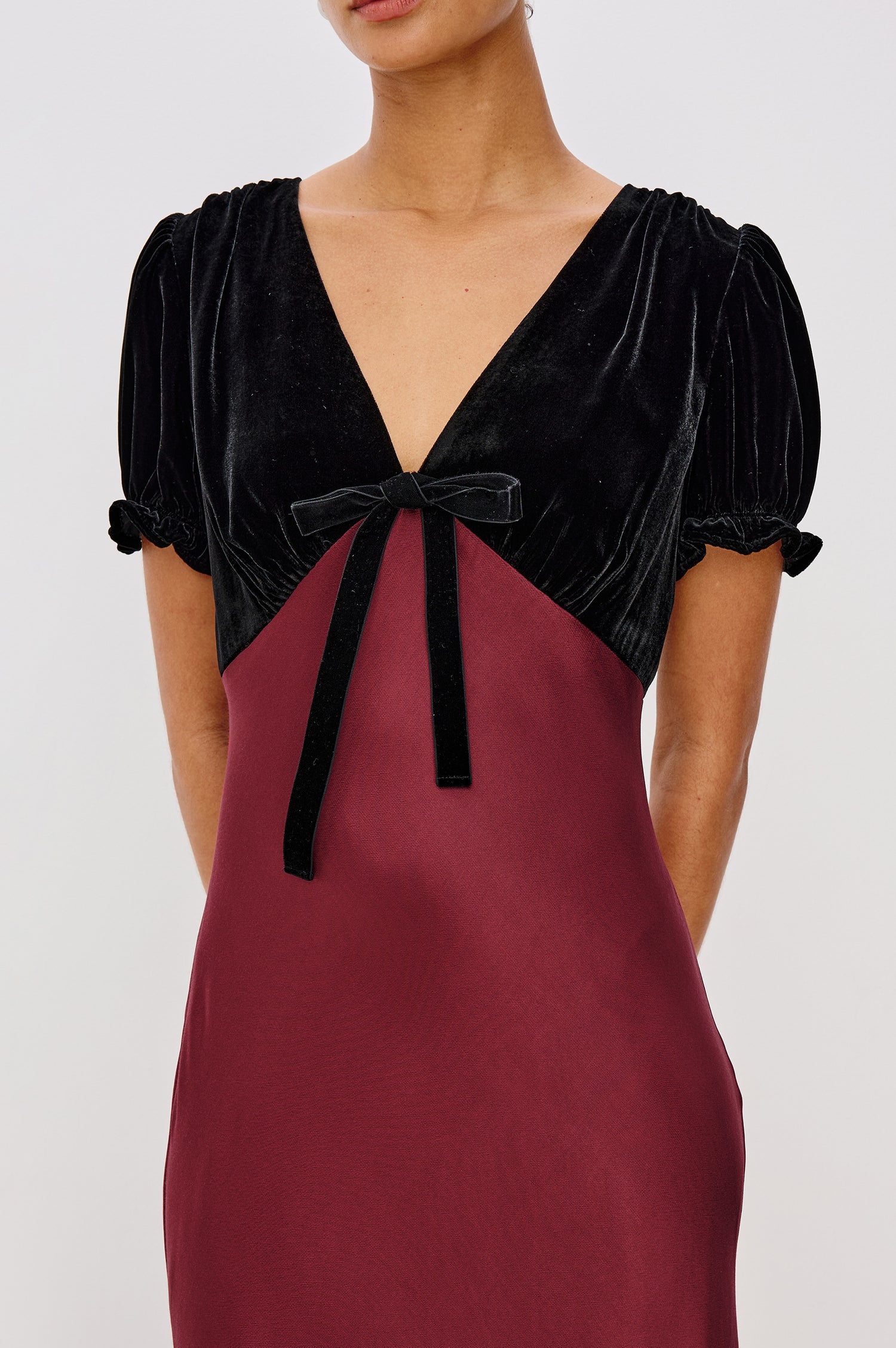 Dory Maxi Dress With Velvet Bodice With V-Neckline and Adjustable Center Bust Ties, Short Puff Sleeves, Satin Back Crepe Skirt, and Back Zipper Closure - Upper Body Front Close Up View Featured on Model