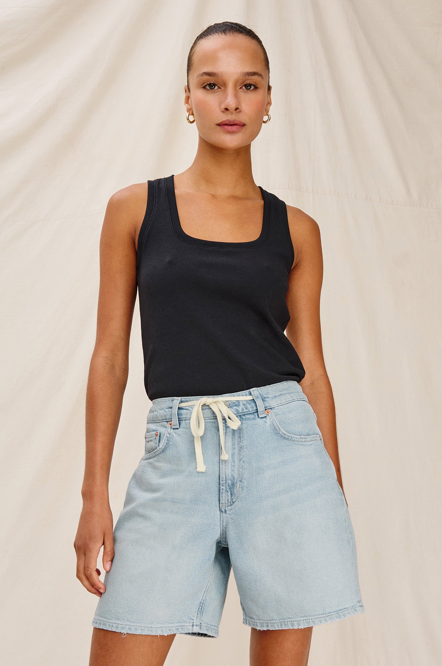 Dume Denim Short, Five Pocket, Zip Fly, Mid-Thigh Length with a White Drawstring Tie Waist in Light Wash Scuba Colorway. Front View Shown on Model.