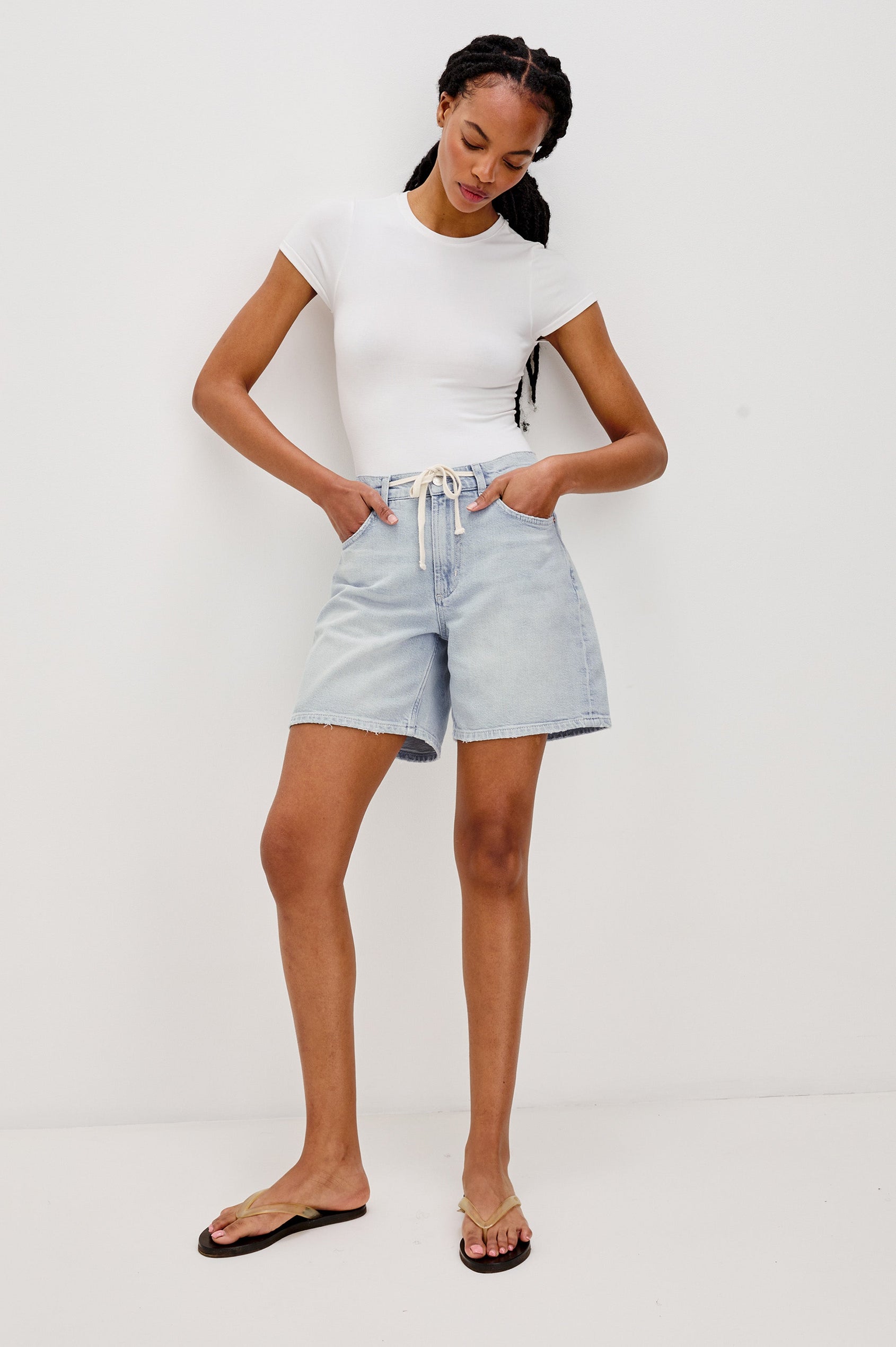 Dume Denim Short, Five Pocket, Zip Fly, Mid-Thigh Length with a White Drawstring Tie Waist in Light Wash Scuba Colorway. Front View Shown on Model.