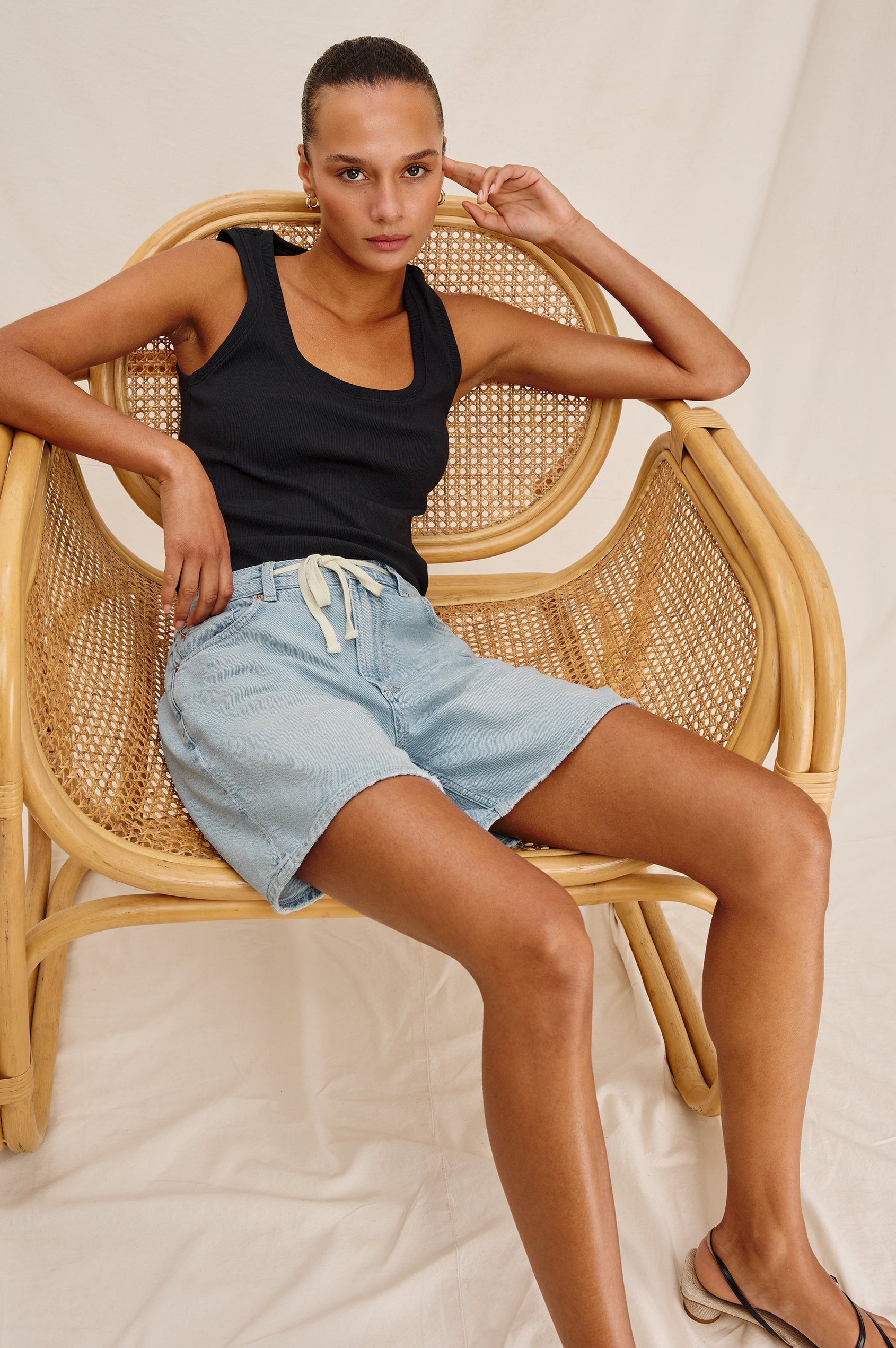 Dume Denim Short, Five Pocket, Zip Fly, Mid-Thigh Length with a White Drawstring Tie Waist in Light Wash Scuba Colorway. Front View Shown on Model.