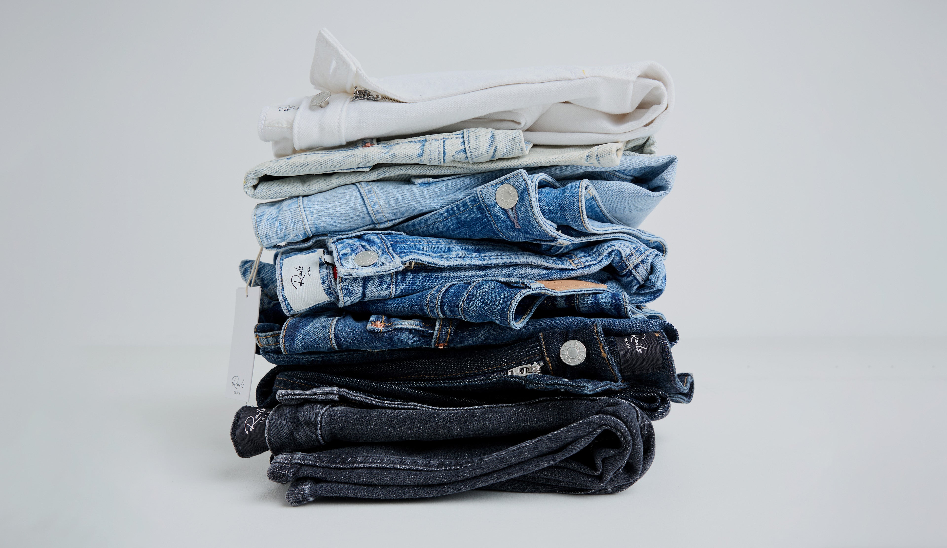 Stacked pair of different colored jeans