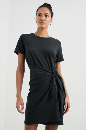 Edie Above-Knee Dress with Short Sleeves, Crew Neckline and Adjustable Wrap Tie At Waist in Vintage Black Colorway - Front View Featured on Model