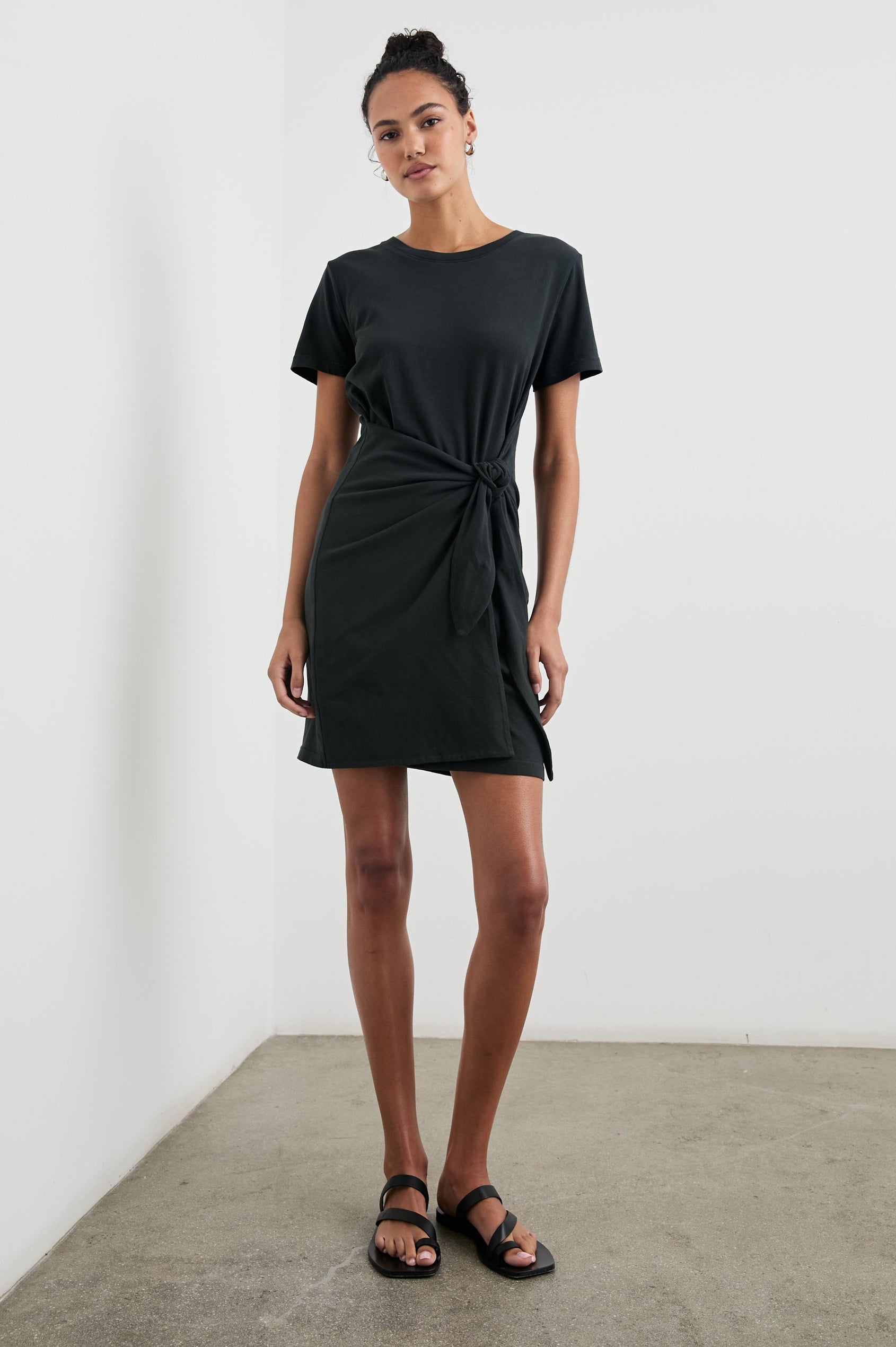 Edie Above-Knee Dress with Short Sleeves, Crew Neckline and Adjustable Wrap Tie At Waist in Vintage Black Colorway - Front Full Body View Featured on Model