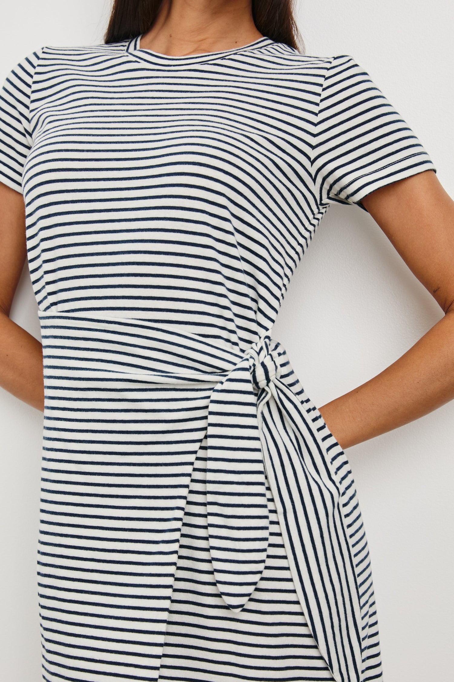 Edie Above-Knee Dress with Short Sleeves, Crew Neckline and Adjustable Wrap Tie At Waist in Ivory Navy Micro Stripe Colorway, Horizontal Stripes - Front View Featured on Model
