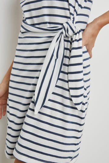 Edie Above-Knee Dress with Short Sleeves, Crew Neckline and Adjustable Wrap Tie At Waist in Ivory Navy Stripe Colorway, Horizontal Stripes - Side View Featured on Model