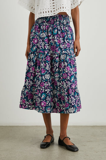 Edina Tiered Midi Skirt with Shirred High-Rise Waistline in Lilac Roses Colorway, with large flowers in purples, blues, and white - Front View Featured on Model
