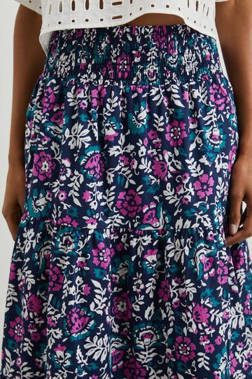 Edina Tiered Midi Skirt with Shirred High-Rise Waistline in Lilac Roses Colorway, with large flowers in purples, blues, and white - Front View Featured on Model