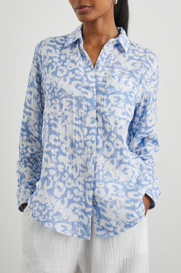 Ellis Long-Sleeve Button Down with Cuffs and a Chest Pocket in Blue Diffused Cheetah Colorway, with a diffused cheetah spot pattern - Front Untucked View Featured on Model